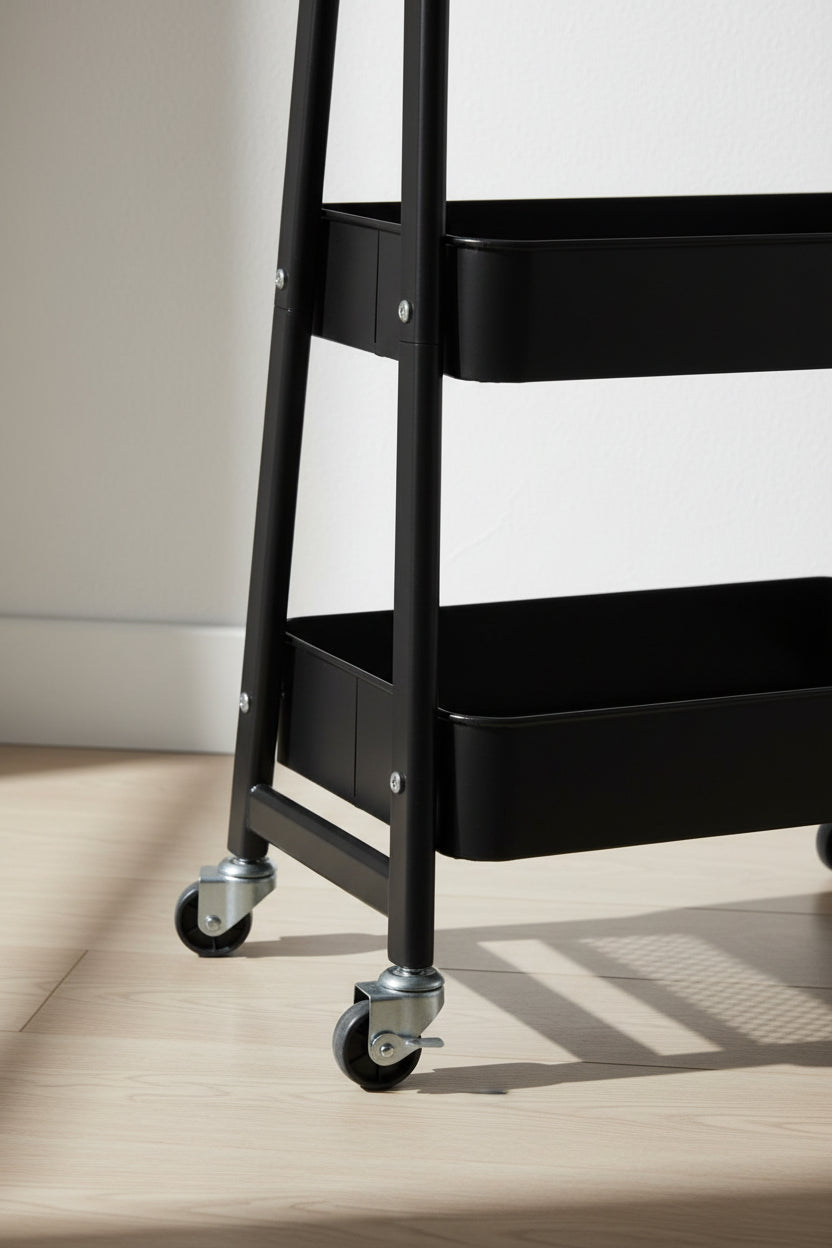 Locking brake lever engaged on the swivel wheel of a black metal storage cart