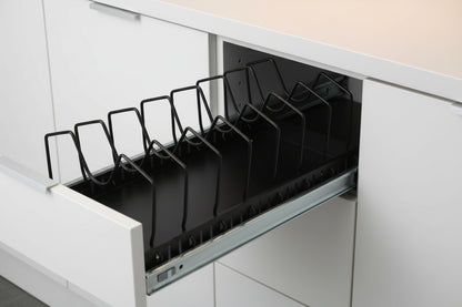Pull-out cookware organizer extended forward from under a white kitchen cabinet