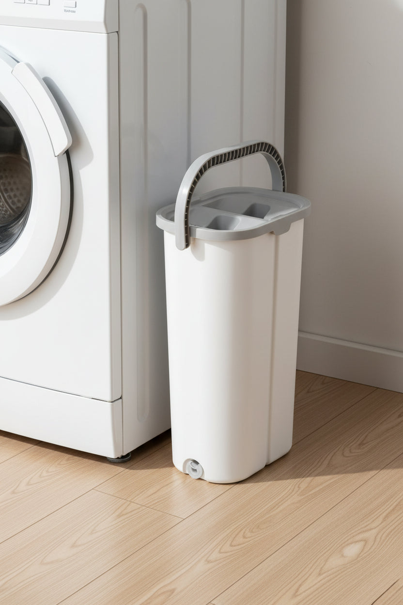 Narrow 7.2 inch mop bucket standing in the gap beside a white washing machine
