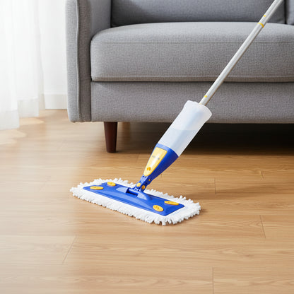 Spray mop head with white microfiber pad sliding flat under sofa edge on hardwood floor